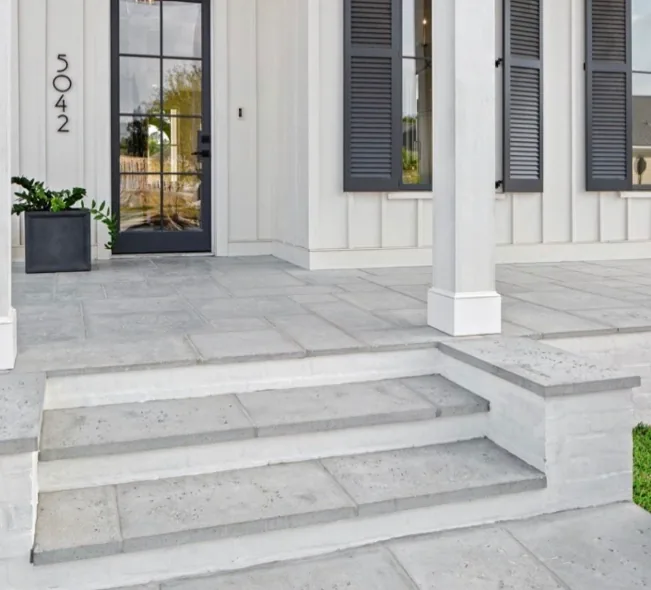 Concrete front steps tied into a porch slab at a residential entry